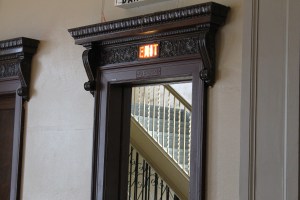 This exit is to the left of the stage. The stairs go up to the church area.