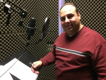 In a sound proof studio recording the narration of the documentary. 